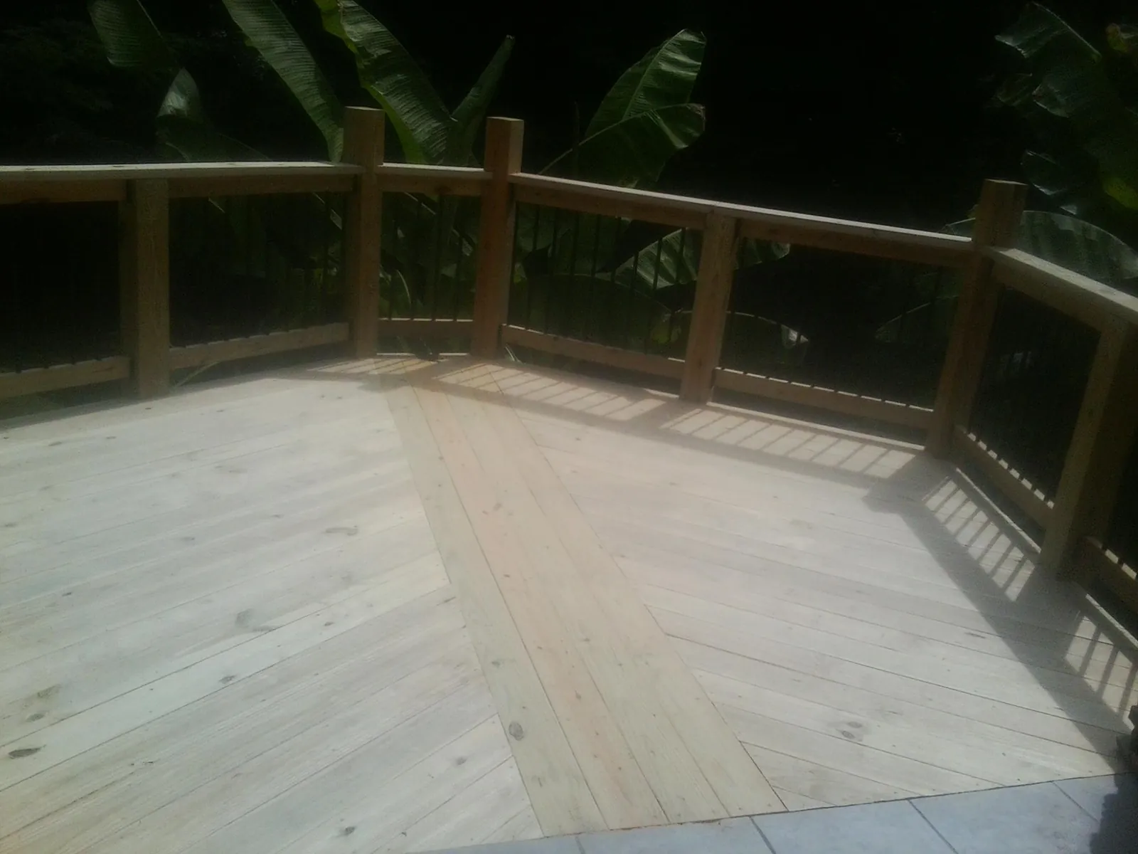 New wood deck and railing built off the back of a home in Rochester